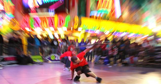 Caleb Jordan competes at the AArrow Sign Spinning company's championship Saturday, Feb. 23, 2013 at the Fremont Street Experience.